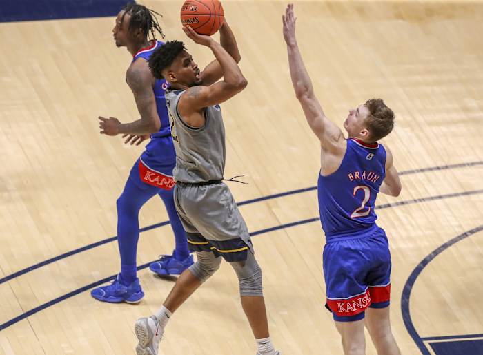 Feb 6, 2021; Morgantown, West Virginia, USA; West Virginia Mountaineers guard Taz Sherman (12) shoots a jumper over Kansas Jayhawks guard Christian Braun (2) during the second half at WVU Coliseum.